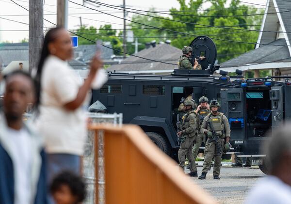 Residents watch as law enforcement search for a fugitive that escaped a prison in New Orleans, Wednesday, May 21, 2025. (Chris Granger/The Times-Picayune/The New Orleans Advocate via AP)