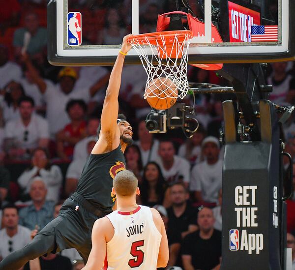 Cleveland Cavaliers center Jarrett Allen dunks in front of Miami Heat forward Nikola Jovic (5) during the first half in Game 3 of an NBA basketball first-round playoff series, Saturday, April 26, 2025, in Miami. (AP Photo/Michael Laughlin)