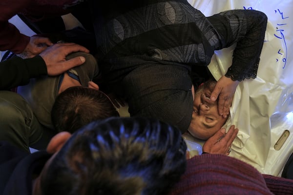 Relatives mourn the body of Ashraf Al Aqqad, who was killed in an Israeli army strike, before his burial at the hospital in Khan Younis, southern Gaza Strip, Thursday, April 3, 2025. (AP Photo/Abdel Kareem Hana)