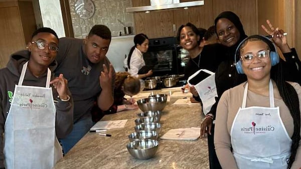 Mays High School senior Ariel Thompson (far right) learned to make chocolate eclairs from scratch during a trip to France for spring break. Atlanta Public Schools launched a new program this year where students can study abroad and stay with a family for a week to learn about language and culture. (Nakai Simmons)