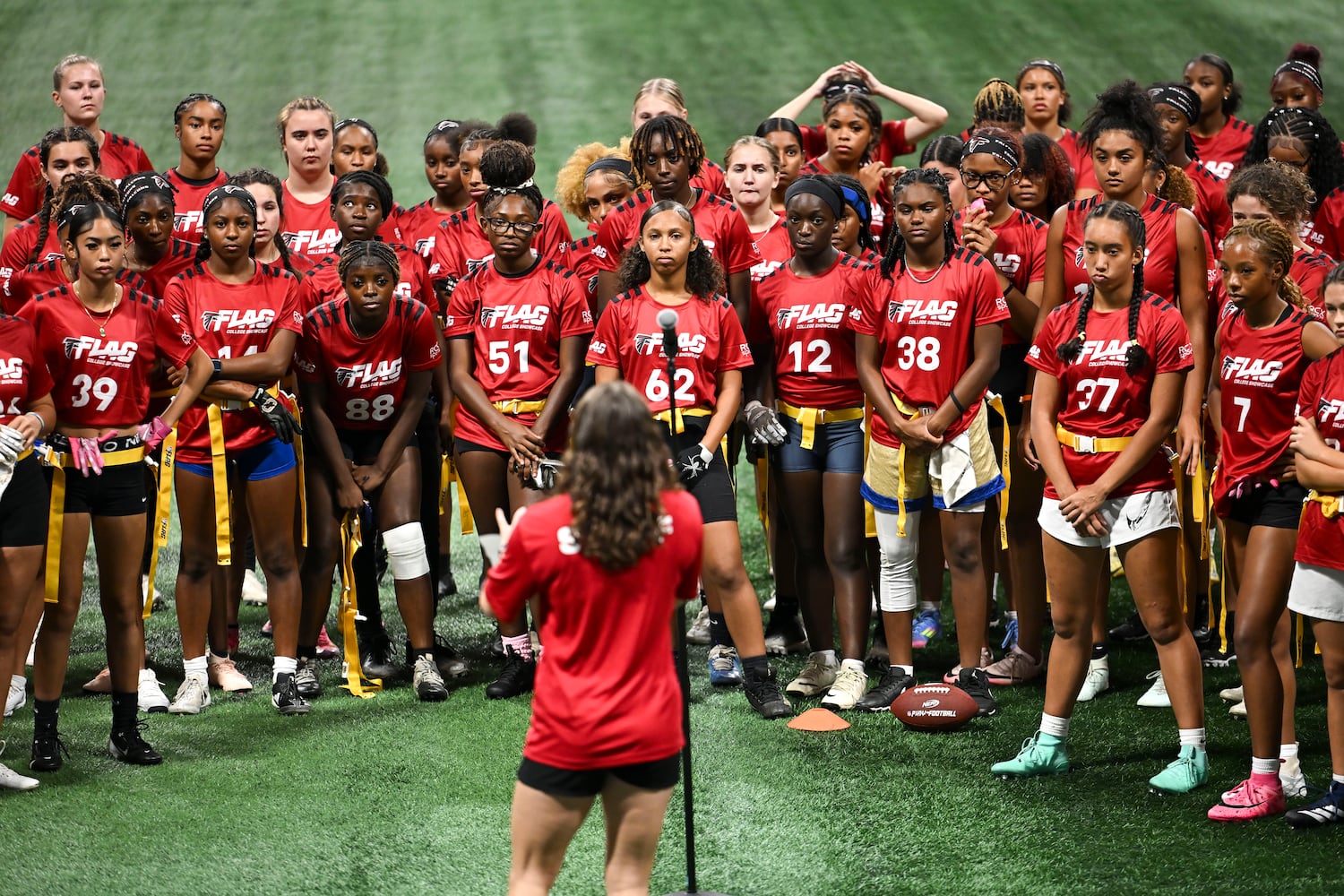 Athletes are welcomed and given instructions during opening remarks of the 5th annual Girls Flag Football Showcase hosted  by the Atlanta Falcons Monday, Aug. 25, 2025 at the Mercedes-Benz Stadium. (Daniel Varnado for the AJC)