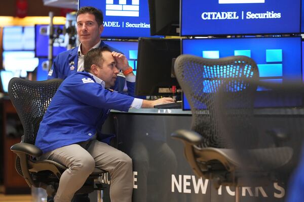 Traders work on the floor at the New York Stock Exchange in New York, Tuesday, April 8, 2025. (AP Photo/Seth Wenig)