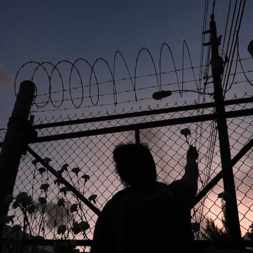 FILE - People place flowers on a fence outside Krome Detention Center in Miami, Saturday, May 24, 2025, during a vigil to recognize people who have died in U.S. Immigration and Customs Enforcement custody as well as those affected by mass deportations. (AP Photo/Rebecca Blackwell, File)
