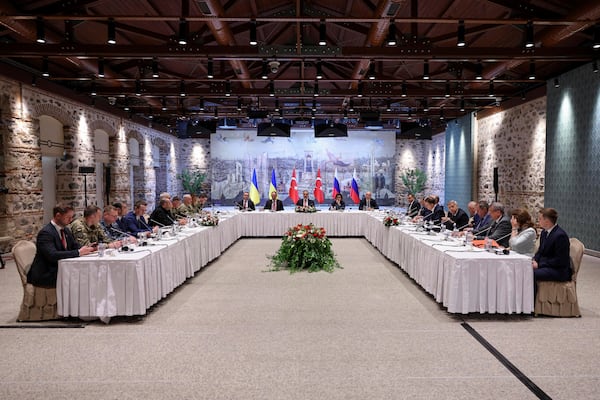In this handout photo released by Turkish Foreign Ministry, Turkish Foreign Minister Hakan Fidan, center, chairs a meeting between delegations from Russia, right, and Ukraine, left, at Dolmabahce palace in Istanbul, Turkey, Friday, May 16, 2025. (Murat Gok/Turkish Foreign Ministry via AP)