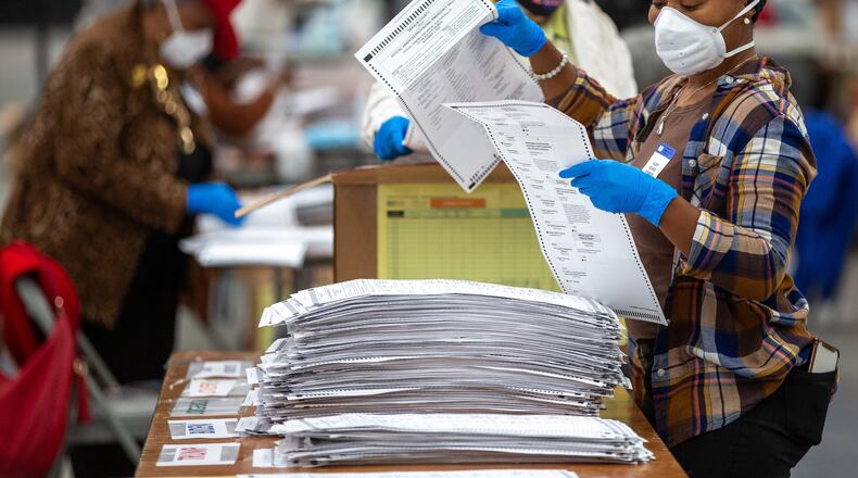 Dekalb County election workers sort presidential ballots during recount efforts in November. A similar recount could follow the state's U.S. Senate runoffs on Jan. 5. (Steve Schaefer/Atlanta Journal-Constitution/TNS)