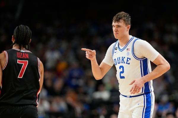Duke's Cooper Flagg (2) points toward Houston's Milos Uzan (7) during the second half in the national semifinals at the Final Four of the NCAA college basketball tournament, Saturday, April 5, 2025, in San Antonio. (AP Photo/Eric Gay)