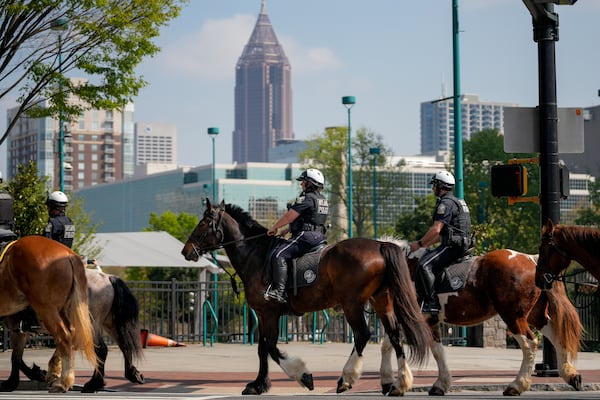 In double-file lines, officers ride their horses through downtown Atlanta on Thursday, March 26, 2026, in areas they will patrol during the World Cup. (Ben Hendren for the AJC)