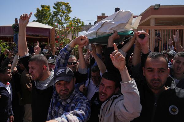 Mourners carry the bodies of 8 Red Crescent emergency responders, recovered in Rafah a week after an Israeli attack, as they are transported for burial from a hospital in Deir al-Balah, Gaza Strip, on Monday, March 31, 2025. (AP Photo/Abdel Kareem Hana)