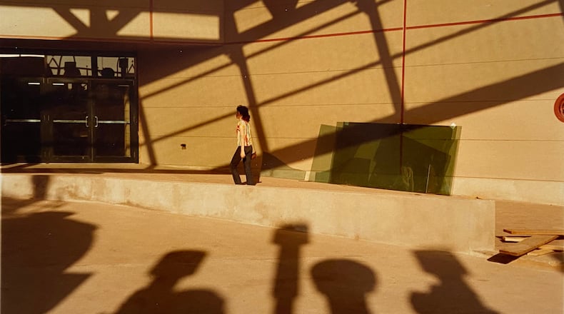 William Eggleston's "Untitled (Atlanta woman walking on sidewalk)" from 
1984.