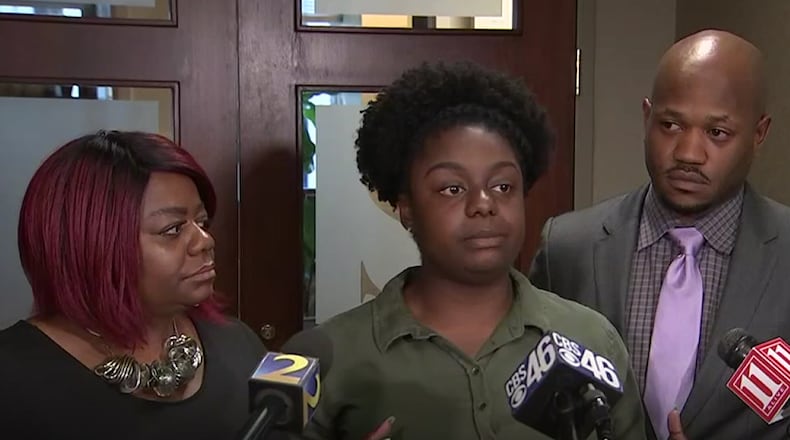 Hope Cheston (center) was accompanied by her mother and lawyer, Chris Stewart, during a news conference after she was awarded $1 billion in a civil lawsuit.