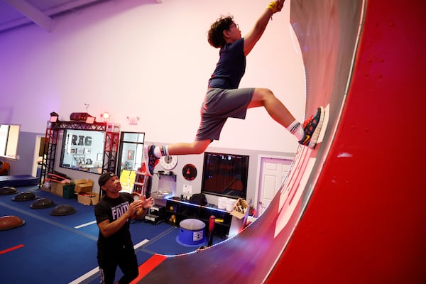 Glenn Davis encourages a camper working on a drill in July at the Rig Gym in Hoschton. Davis says, “I want everybody when they leave here feeling like they are achieving something." (Miguel Martinez/AJC)