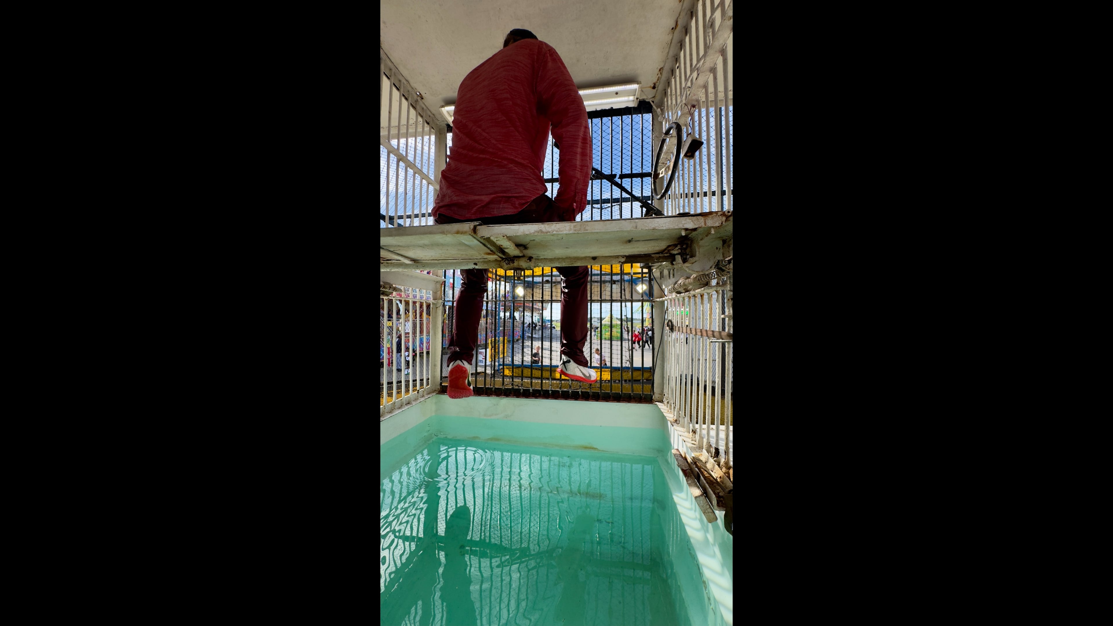 Justin Smith awaits his fate, seated above a tub of water, in the Soak the Bloke booth at the Georgia National Fair. (Joe Kovac Jr./AJC)