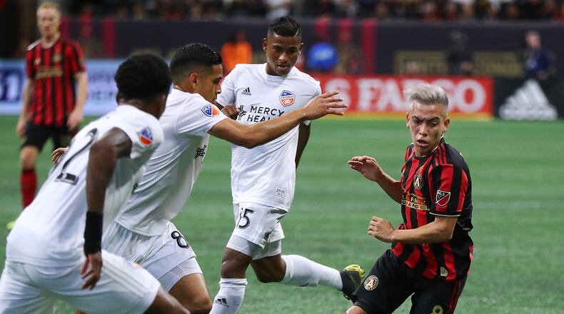March 10, 2019 Atlanta: Atlanta United midfielder Ezequiel Barco if forced to work the ball away from FC Cincinnati defenders Alvas Powell (from left), Victor Ulloa, and Allan Cruz during the first half in their MLS soccer match on Sunday, March 10, 2019, in Atlanta. Curtis Compton/ccompton@ajc.com