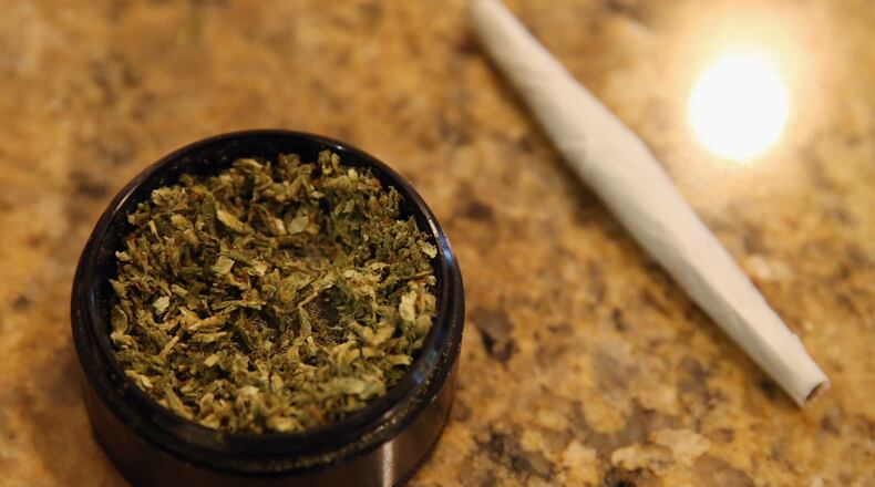 A closeup view of marijuana in a grinder along with a cigarette as photographed on August 30, 2014 in Bethpage, New York. (Photo by Bruce Bennett/Getty Images)