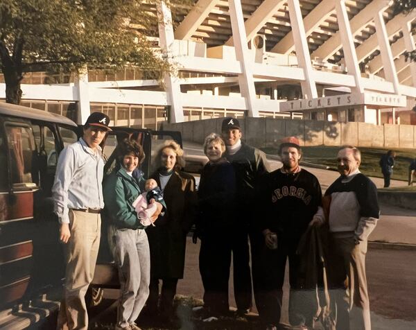 Braves fan Joe Sturniolo (left) joins Kay Sturniolo holding 9-week-old Katie Sturniolo, Jody Shipley, Sue Sturniolo, Walt Haber, Ed Thomas and Joe Sturniolo, his father who attended the 1989 opener with him.