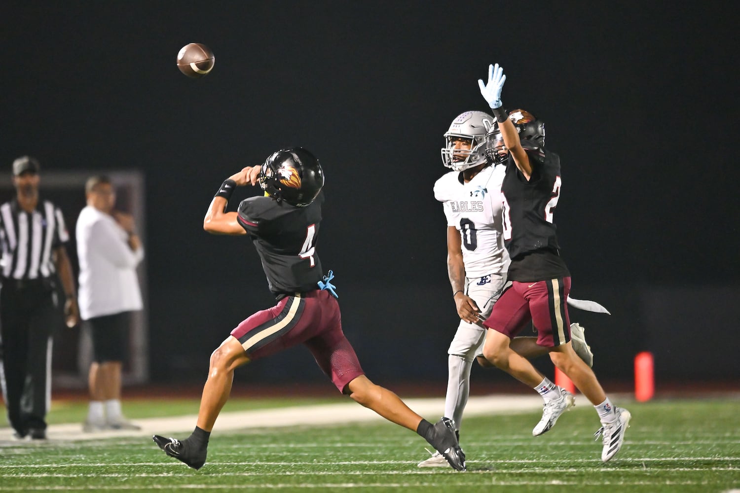 Hebron defensive back Masen Hardy (left) loses control of the ball on an attempted interception over East Jackson running back Jamarion Parks (center) during the second half of play Friday, Sept. 26, 2025, at Hebron Christian Academy. (Daniel Varnado for the AJC)