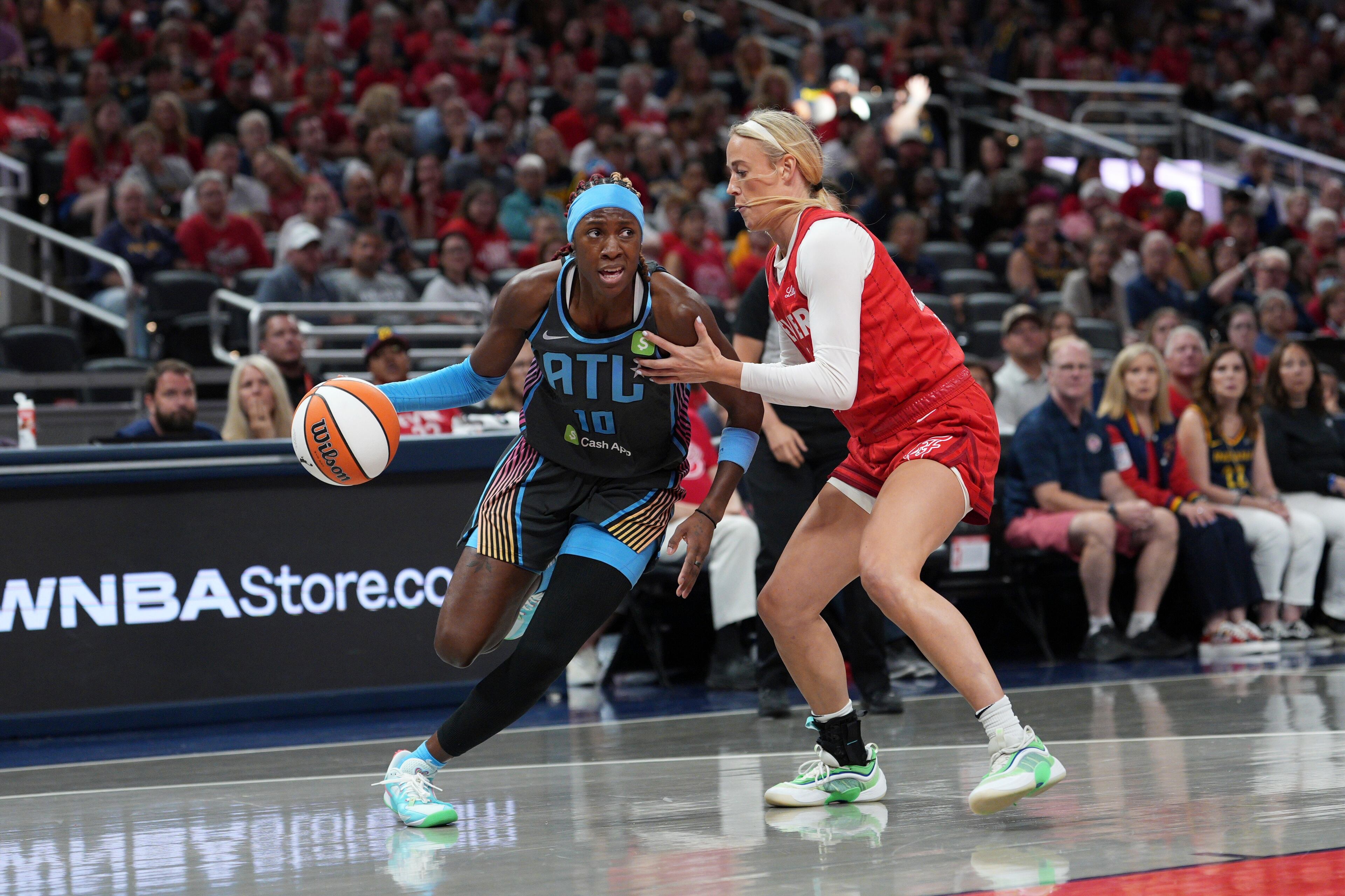 The Dream's Rhyne Howard (left) goes to the basket against the Fever's Sophie Cunningham on Friday, July 11, 2025, in Indianapolis. Howard finished the game with 14 points. (AJ Mast/AP)