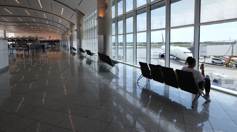 March 30, 2020 Atlanta: Nalim Nunes has the ticket area of Atlanta Hartsfield-Jackson's international terminal to herself while waiting on her Delta Air Lines flight home to Brazil on Monday, March 30, 2020, in Atlanta. Nunes is a hospitality worker at a Charleston hotel and decided to return home after her job was lost during the coronavirus. Curtis Compton ccompton@ajc.com