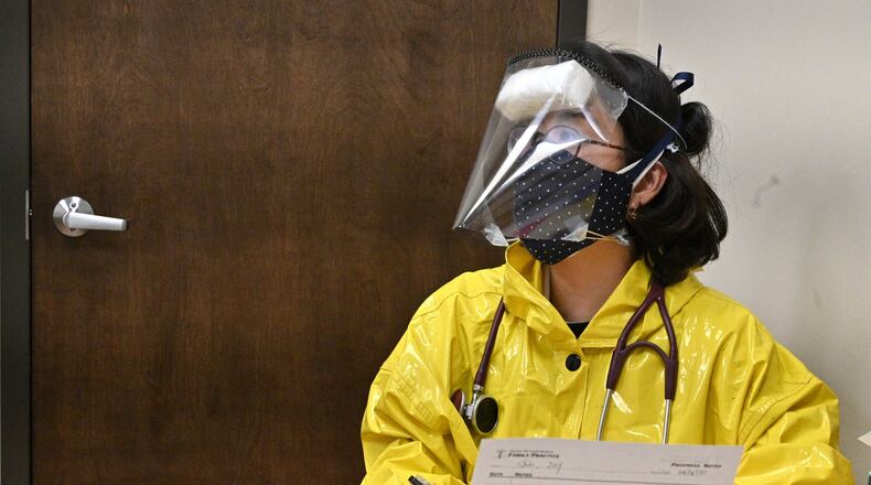 Dr. Jina Yoon Kim wearing hand made protection suits prepares to administer a flu test to a patient at Pleasant Hill Family Medicine in Duluth on Friday, April 3, 2020. HYOSUB SHIN / HYOSUB.SHIN@AJC.COM