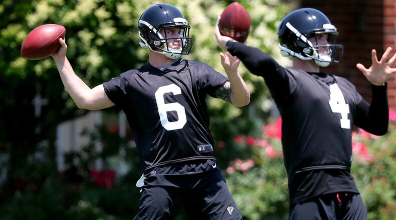 Falcons rookie quarterbacks Kurt Benkert (left) and Bryan Scott pass during rookie minicamp on Friday, May 11, 2018, in Flowery Branch. Curtis Compton/ccompton@ajc.com