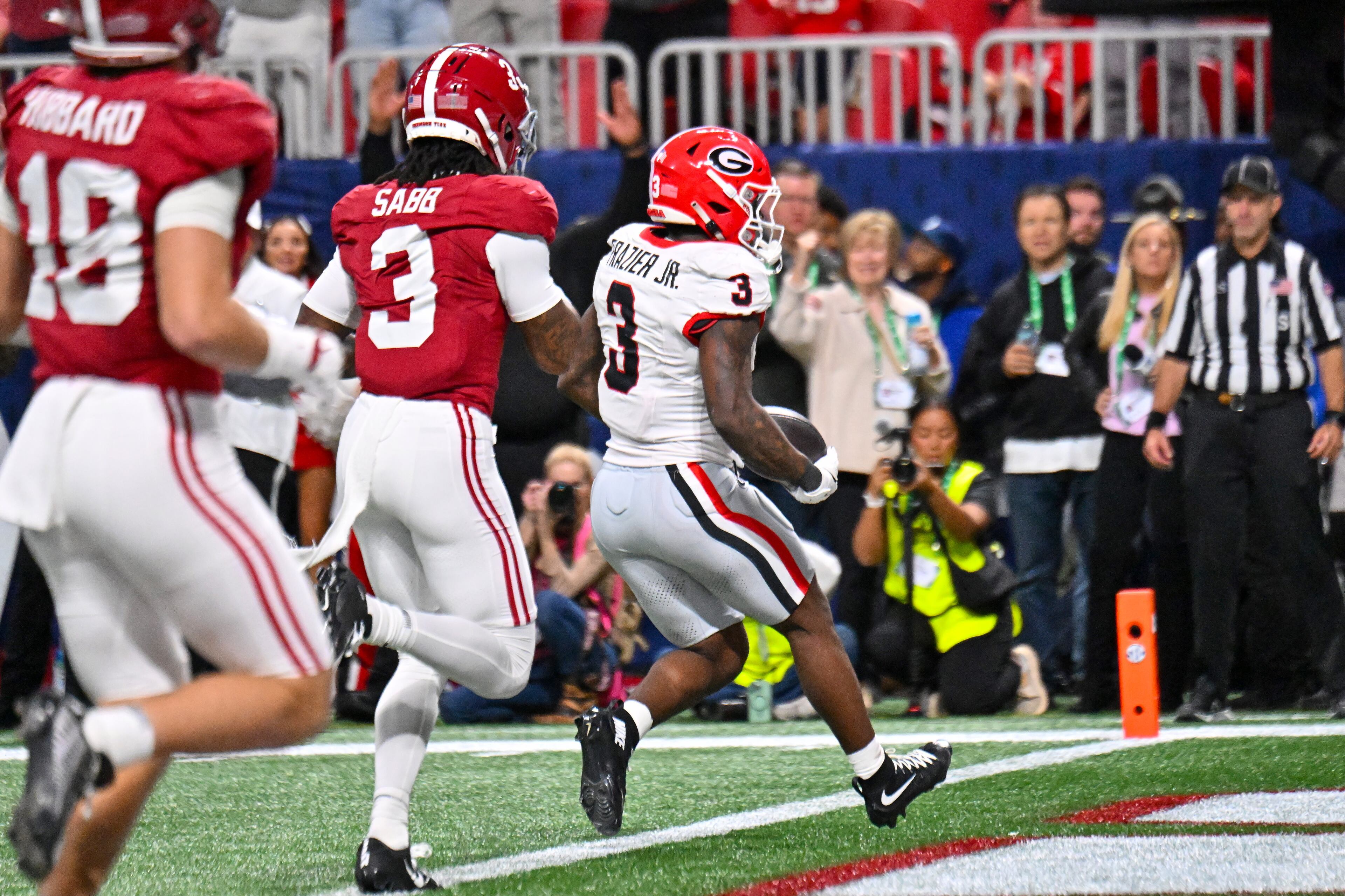 Georgia running back Nate Frazier (3) runs nine yards for a touchdown against Alabama defensive back Keon Sabb (3) during the third quarter of the SEC Championship game at Mercedes-Benz Stadium, Saturday, Dec. 6, 2025, in Atlanta. (Hyosub Shin / AJC)