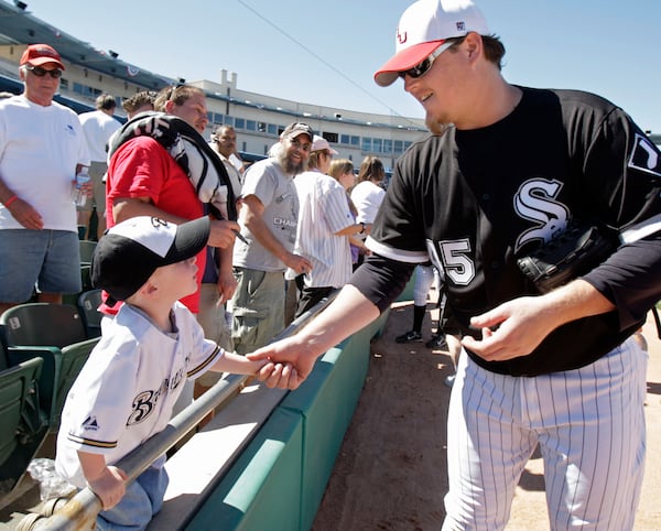 FILE - Chicago White Sox's Bobby Jenks shakes hands with 3-year-old Gherig Gesch before the White Sox's spring training baseball game against the Colorado Rockies on Feb. 27, 2008, in Tucson, Ariz. (AP Photo/M. Spencer Green, File)