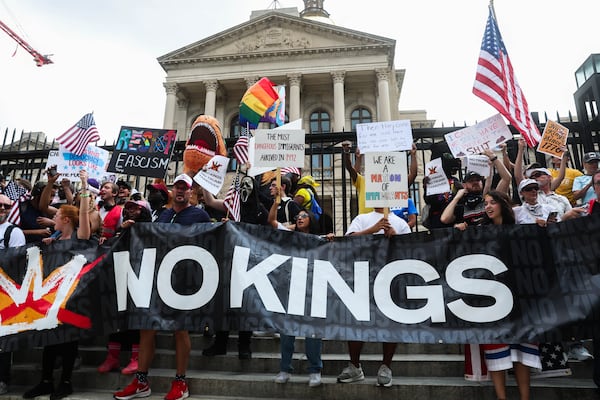 Demonstrators hold signs during a "No Kings" march in Atlanta last October. Thousands marched to the state Capitol to protest the Trump administration. (Abbey Cutrer/AJC)