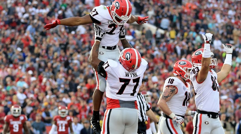 PASADENA, CA - JANUARY 01: Nick Chubb #27 of the Georgia Bulldogs and Isaiah Wynn #77 of the Georgia Bulldogs celebrate after a 50 yard touchdown in the 2018 College Football Playoff Semifinal Game against the Oklahoma Sooners at the Rose Bowl Game presented by Northwestern Mutual at the Rose Bowl on January 1, 2018 in Pasadena, California.  (Photo by Sean M. Haffey/Getty Images)