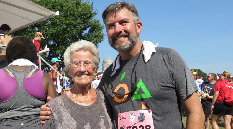 Betty Lindberg (left) poses with her son Craig (right) following their completion of the Atlanta Journal-Constitution Peachtree Road Race on July 4, 2016. PHOTO BY JORDAN D. HILL/JORDAN.HILL@AJC.COM