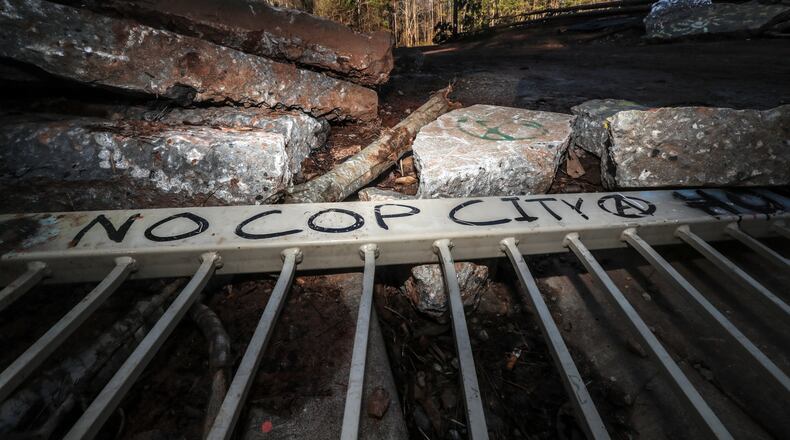 January 20, 2023 ATLANTA: (on West Side Place near Bouldercrest Road) There are visible signs of protest on Friday, Jan. 20, 2023 at the site of Atlanta’s planned public safety training center where a GSP trooper exchanged gunfire with a protester last Wednesday morning, leaving the protester dead and a state trooper wounded. For more than a year now, the site and surrounding areas bordering Key Road, Bouldercrest Road, Constitution and Fayetteville Road in southwestern DeKalb County have been an epicenter for controversy and clashes between activists and law enforcement. Six people were arrested last month and charged with domestic terrorism in relation to activities trying to stop progress on the training center. More traditional forms of protest have taken place, including a demonstration outside the DeKalb County District Attorney’s Office on Martin Luther King Jr. Day. But extreme activists have also thrown Molotov cocktails, rocks and other objects at police and contractors on the site. They’ve destroyed machinery. And anonymous bloggers have claimed responsibility for vandalism across the state and the country, at homes and businesses they deem to be sympathetic to or directly involved in construction of the $90 million facility. The “forest defenders” see the training center — which they’ve derisively dubbed “cop city” — as Atlanta doubling down on the militarization of police and controversial tactics even in the wake of 2020′s social justice protests. They also say the destruction of the forest will exacerbate climate change and lead to more pollution in an area that’s already been historically neglected. (John Spink / John.Spink@ajc.com)