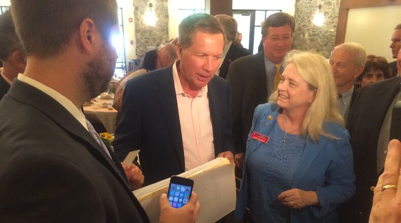Ohio Gov. John Kasich mingles with the audience after a speech to Fulton County Republicans.