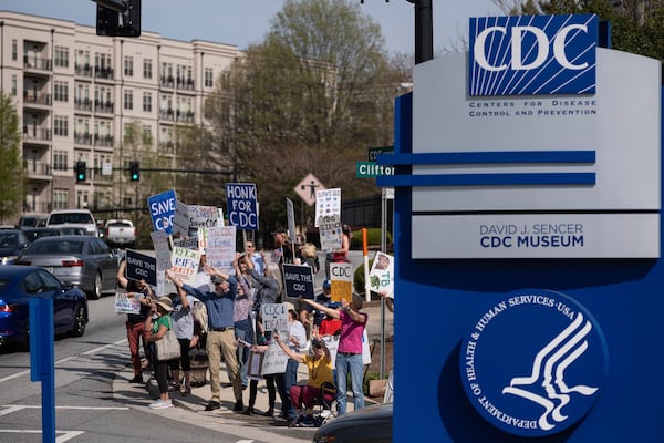 People protest in support of the Centers for Disease Control and Prevention in front of the headquarters in Atlanta, Tuesday, April 1, 2025 after layoffs were announced. (AP Photo/Ben Gray)