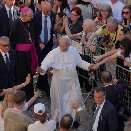 Faithful reach out to Pope Leo XIV as he leaves Pavia Cathedral in northern Italy, Saturday, June 20, 2026. (AP Photo/Antonio Calanni)