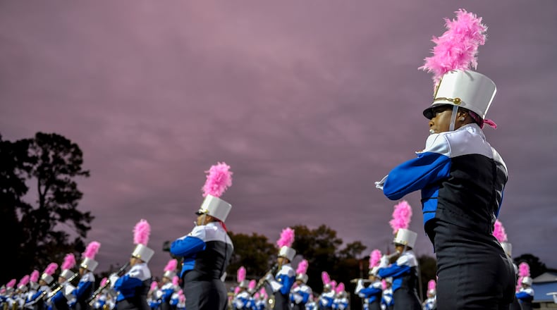 Members of the McEachern marching band perform the National Anthem prior to the start of a 2016 game.