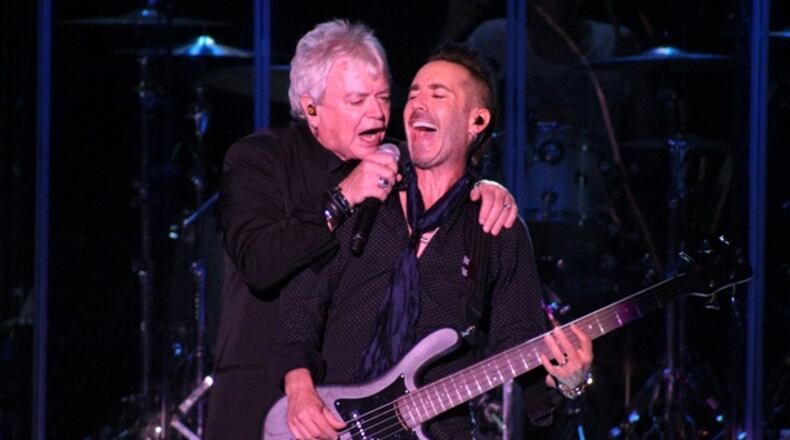 Air Supply's Russell Hitchcock and bassist Derek Frank share a moment during Friday's concert at Chastain. Photo: Melissa Ruggieri/AJC