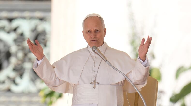 Pope Leo XIV blesses faithful as he starts his weekly general audience in St. Peter's Square, at the Vatican, Wednesday, April 8, 2026. (AP Photo/Gregorio Borgia)