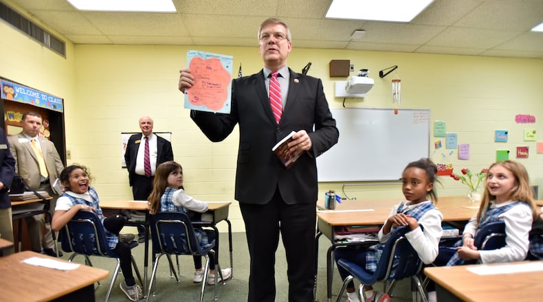March 11, 2015 Atlanta - Freshman U.S. Rep. Barry Loudermilk (center) holds "Thank you" memos from students after he read "American History Stories" in 3rd grade classroom at Atlanta Classical Academy on Wednesday, March 11, 2015. Freshman Atlanta area U.S. Reps. Jody Hice and Barry Loudermilk campaigned on bringing a sharp new conservative voice to Washington. HYOSUB SHIN / HSHIN@AJC.COM Rep. Barry Loudermilk (AJC/Hyosub Shin)