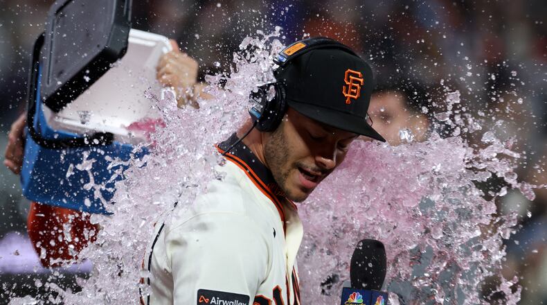 San Francisco Giants' Grant McCray is doused by teammates after their team's victory over the Milwaukee Brewers during a baseball game in San Francisco, Monday, July 27, 2026. (AP Photo/Jed Jacobsohn)