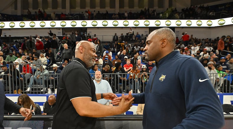 McEachern's head coach Tremayne Anchrum and Wheeler's head coach Larry Thompson shake hands after McEachern beat Wheeler during GHSA Class 7A Semifinal basketball game at GSU’s Convocation Center, Saturday, Mar. 2, 2024, in Atlanta. (Hyosub Shin/AJC)