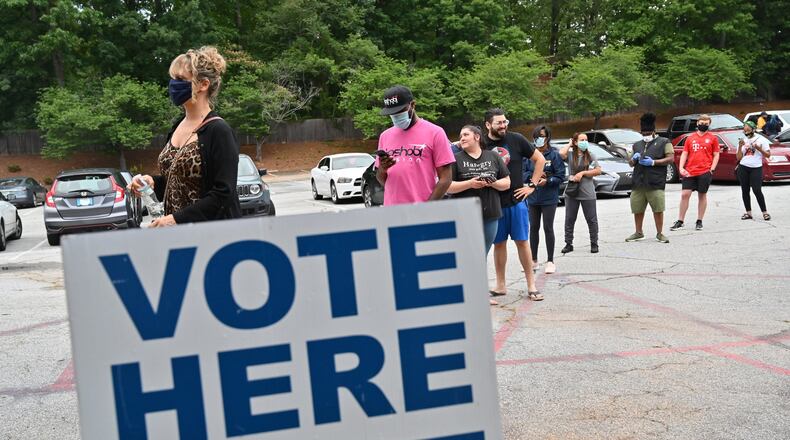 DeKalb County residents wait outside Ray Hope Christian Church in Decatur to cast their votes in the Georgia primary after 7 p.m. Tuesday, the original poll closing time. (Hyosub Shin / Hyosub.Shin@ajc.com)