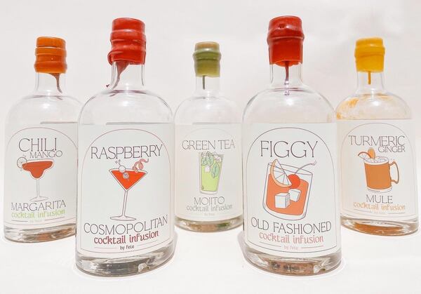 Several cocktail infusion bottles of different flavors.