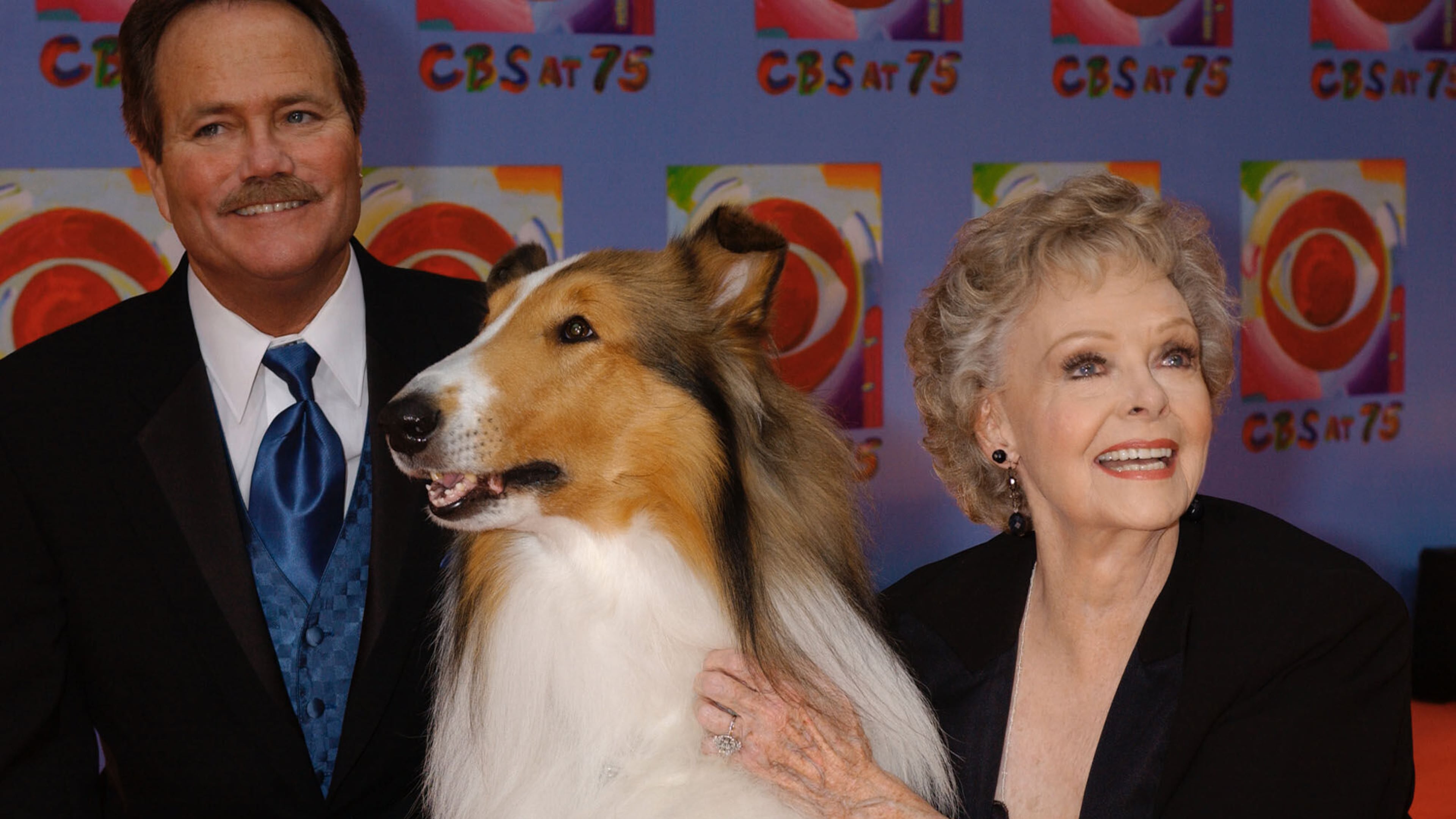 FILE - June Lockhart, right, who played the character of Ruth Martin, mother of Timmy Martin, played by Jon Provost, left, during the classic series "Lassie," poses for a photograph with Lassie, 9th generation, during arrivals at CBS's 75th anniversary celebration Sunday, Nov. 2, 2003, in New York. (AP Photo/Louis Lanzano, File)