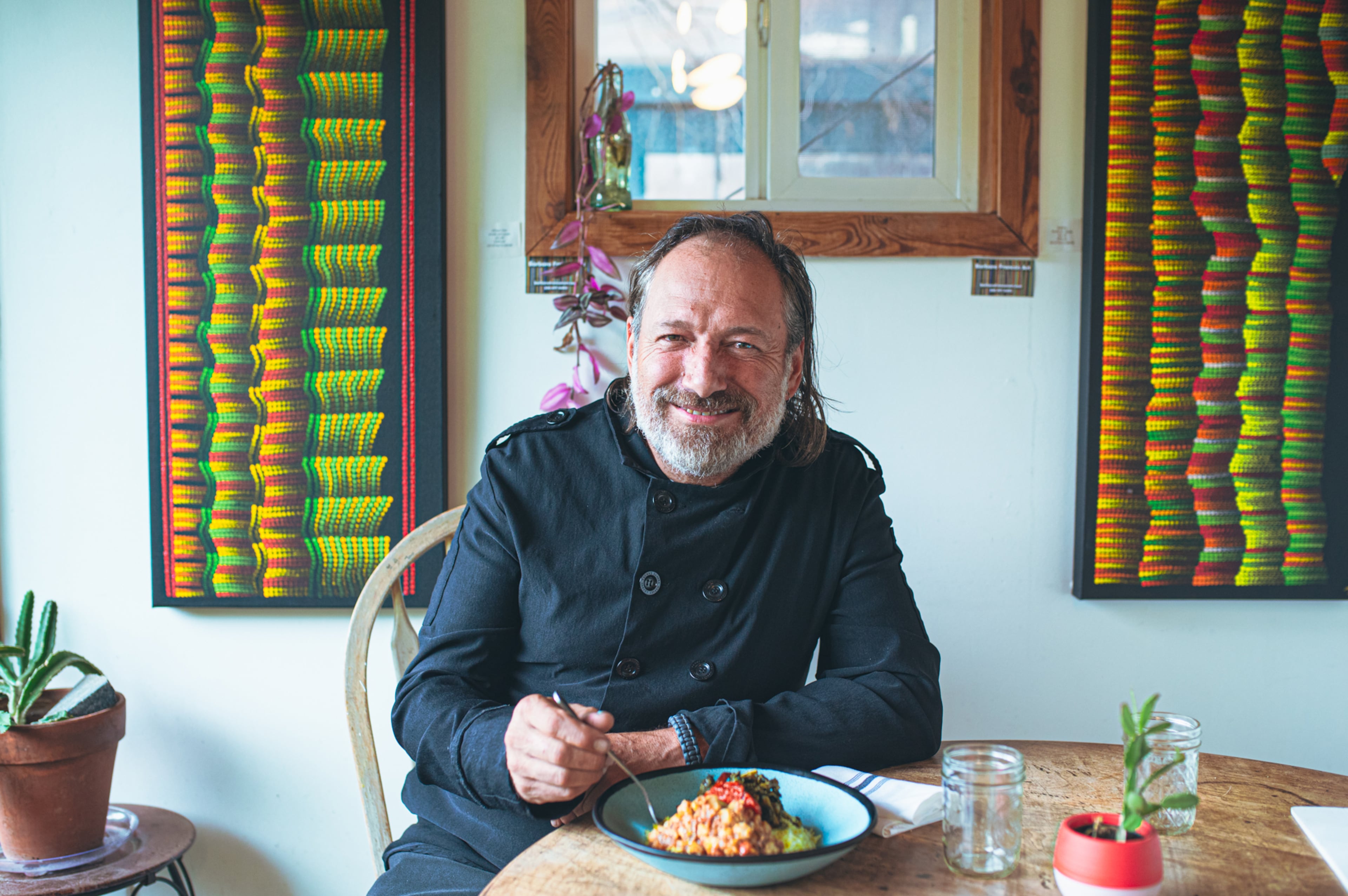 AAJC092224 Black Mountain, NC: Executive chef and owner Mark Henegan of The Bush Mountain Farmhouse sits down to eat the restaurant's signature Hoppin' John. Photo taken September 5, 2024 at The Bush Mountain Farmhouse. AAJC 092224 southern classics vegan bbq (GRACE DICKINSON FOR THE THE ATLANTA JOURNAL-CONSTITUTION)