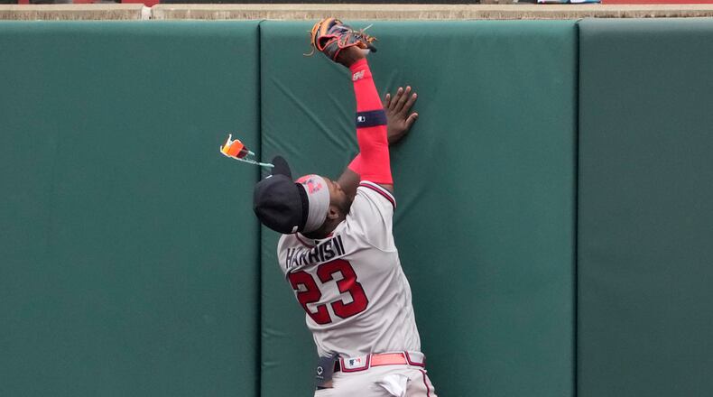 Atlanta Braves center fielder Michael Harris II (23) loses his glasses as he hits the outfield wall catching a fly ball by St. Louis Cardinals' Paul Goldschmidt to end the eighth inning of a baseball game Wednesday, April 5, 2023, in St. Louis. (AP Photo/Jeff Roberson)