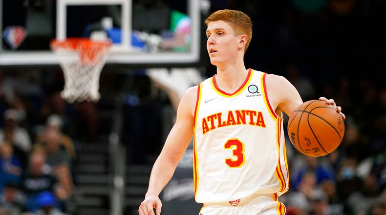 Atlanta Hawks guard Kevin Huerter (3) moves the ball against the Orlando Magic during the first half of an NBA basketball game, Wednesday, Dec. 15, 2021, in Orlando, Fla. (AP Photo/John Raoux)