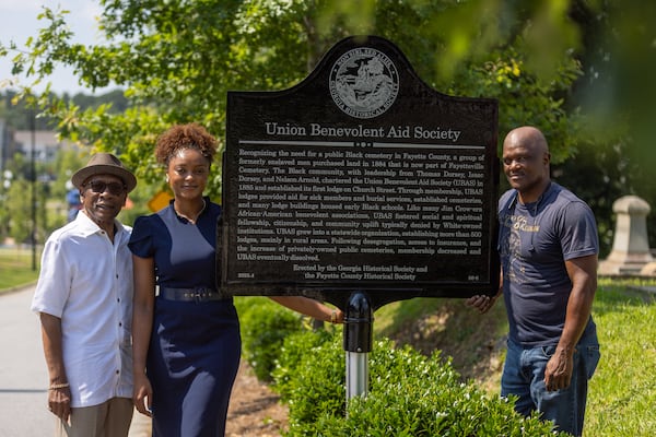 (L-R) Paul Ponder, Tamara Dorsey and Thomas Dorsey pose for a portrait at a historical marker honoring the Union Benevolent Aid Society, started by their ancestors, at the Fayetteville Cemetery in Fayetteville on Tuesday, June 24, 2025. (Arvin Temkar/AJC)