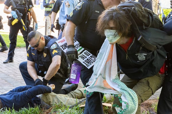 Police arrest pro-Palestinian protesters who set up an encampment at the Emory campus in Atlanta on Thursday, April 25, 2024. (Arvin Temkar / AJC)