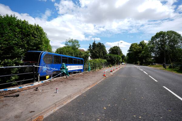 A double-decker bus carrying high school students after it came off the road and plunged into a river, in Eastleigh, England, Thursday June 26, 2025. (Andrew Matthews/PA via AP)