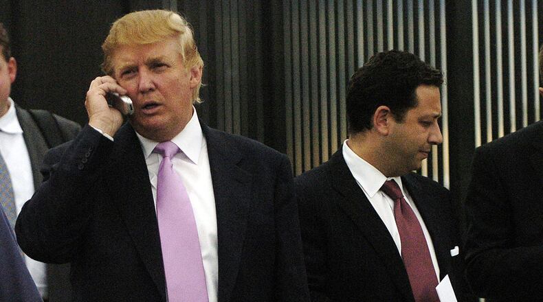 In this Sept. 14, 2005, file photo, businessman Donald Trump, left, talks on his cellphone with Felix Sater, right, outside after speaking at the Bixpo 2005 business convention at the Budweiser Events Center in Loveland, Colorado.