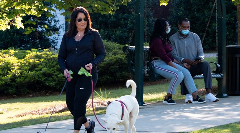 Dena Harmon walks her dogs, Alice and Lucy, at Taylor-Brawner Park in Smyrna on Monday evening April 20. Harmon owns Paws Amore, a dog walking and sitting business. Ben@BenGray.com for The Atlanta Journal-Constitution